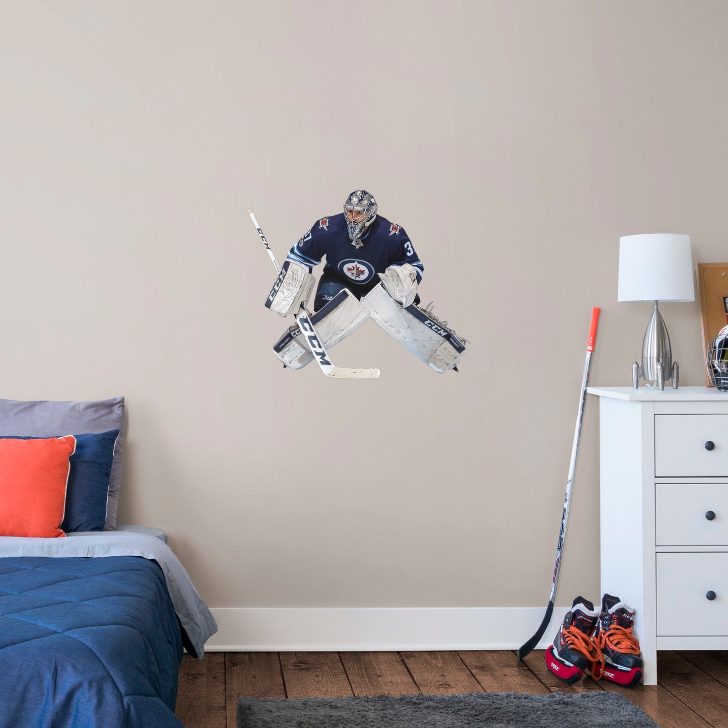 X-Large Athlete + 2 Decals (29"W x 25"H) Opposing teams should be worried when they see Connor Hellebuyck in the goal, and now you can bring his epic defense skills to life in your own home with this Officially Licensed NHL removable wall decal. Pictured here ready to stop any puck that comes his way, this wall decal of Hellebuyck will make the perfect addition to your bedroom, office, or fan room, and it even makes a great gift for your favorite Jets fanatic!