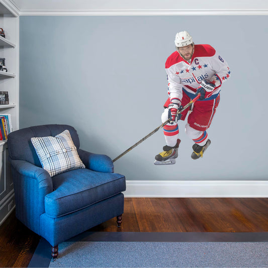 Athlete +9 Team Decals (72"W x 72"H) NHL fans and Capitals fanatics alike love Alex Ovechkin, the clutch captain from Washington D.C., and now you can bring his skill to life in your own home! Seen here in his away uniform in action on the ice, this durable, bold, and removable wall decal will make the perfect addition to your bedroom, office, fan room, or any spot in your house! Let's Go Caps!