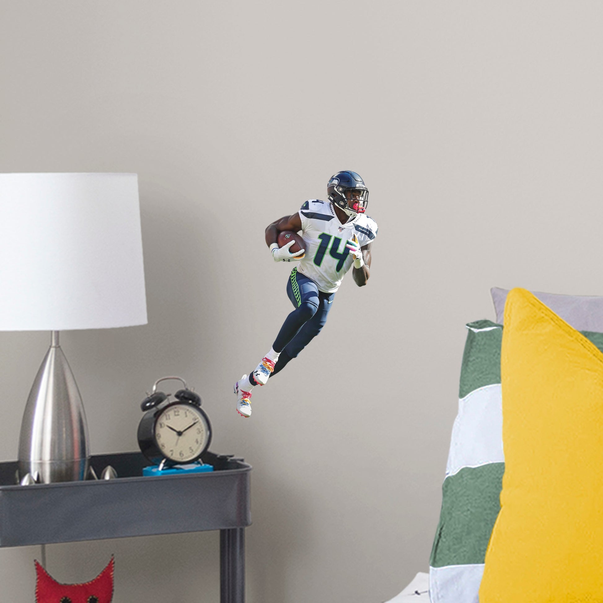Large Athlete + 2 Decals (10"W x 16.5"H) Outmaneuver boring walls with this removable wall decal featuring D.K. Metcalf showing other players how to roll with it. This quality, giftable decal showcases Baby Bron in mid-sprint, clutching the football defensively while wearing the Seahawks' signature College Navy, Action Green, and Wolf Gray colors. This durable decal will help you demonstrate a strong offense in your bedroom, office, or entertainment room.