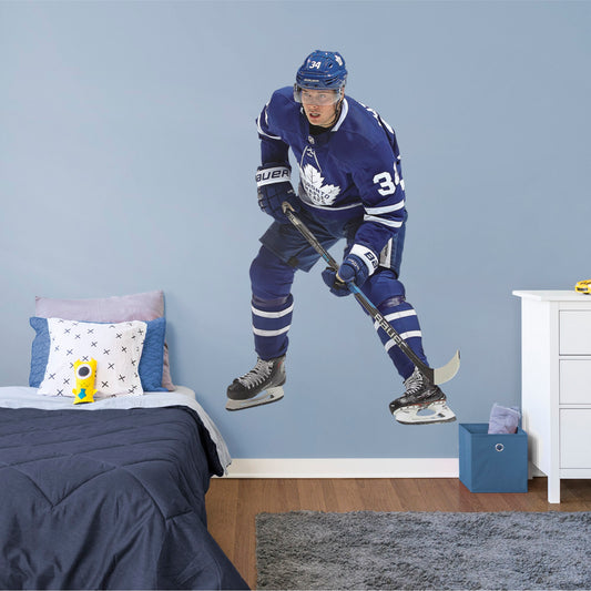 Life-Size Athlete + 2 Decals (48"W x 76"H) He was the first NHL player in modern history to land four goals in his league debut, and now, you can make the Toronto Maple Leafs��� center Auston Matthews part of your bedroom, hallway or game room. Affectionately known as Matty, Austino and Mustache, among other monikers, this durable, tear-resistant NHL wall decal features No. 34 in his navy blue and white Maple Leafs best.