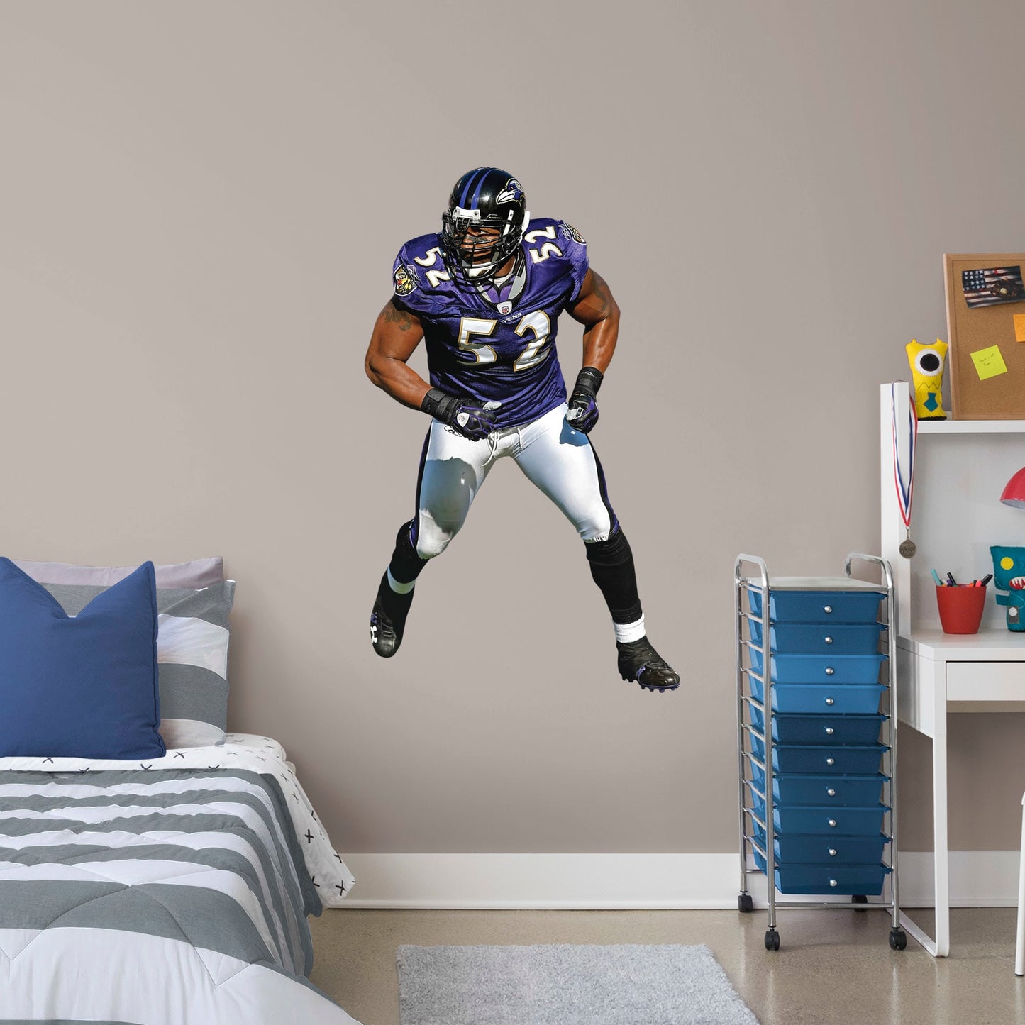 Giant Athlete + 2 Decals (31"W x 51"H) He's the second linebacker ever to win the NFL's Super Bowl MVP Award, and now, Brickwall, a.k.a. Ray Lewis, is ready for the bedroom, living room or locker room. This rugged, removable wall decal features the full figure of two-time Super Bowl champion No. 52 in his black, purple and metallic gold Baltimore Ravens best. Go Ravens!