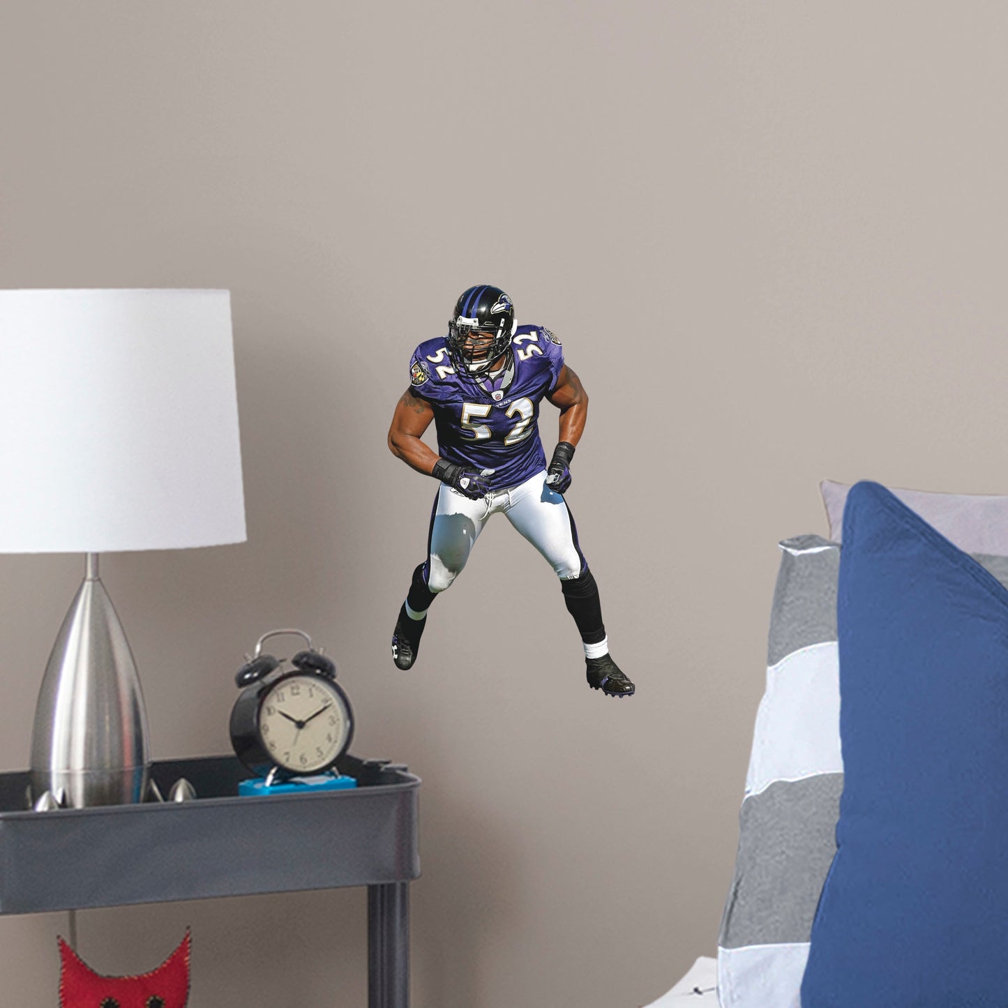 Large Athlete + 2 Decals (10"W x 16"H) He's the second linebacker ever to win the NFL's Super Bowl MVP Award, and now, Brickwall, a.k.a. Ray Lewis, is ready for the bedroom, living room or locker room. This rugged, removable wall decal features the full figure of two-time Super Bowl champion No. 52 in his black, purple and metallic gold Baltimore Ravens best. Go Ravens!