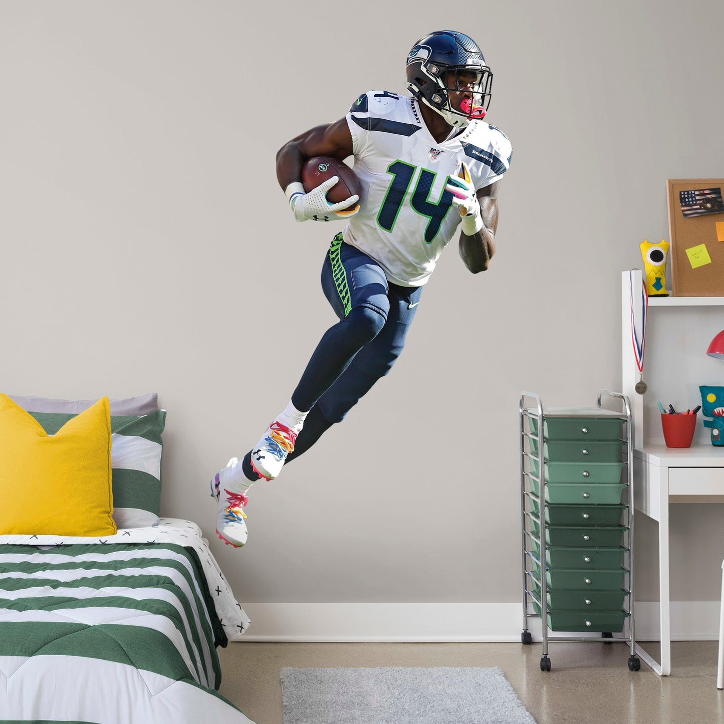 Life-Size Athlete + 2 Decals (45"W x 78"H) Outmaneuver boring walls with this removable wall decal featuring D.K. Metcalf showing other players how to roll with it. This quality, giftable decal showcases Baby Bron in mid-sprint, clutching the football defensively while wearing the Seahawks' signature College Navy, Action Green, and Wolf Gray colors. This durable decal will help you demonstrate a strong offense in your bedroom, office, or entertainment room.