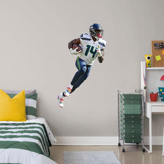 Giant Athlete + 2 Decals (30"W x 51"H) Outmaneuver boring walls with this removable wall decal featuring D.K. Metcalf showing other players how to roll with it. This quality, giftable decal showcases Baby Bron in mid-sprint, clutching the football defensively while wearing the Seahawks' signature College Navy, Action Green, and Wolf Gray colors. This durable decal will help you demonstrate a strong offense in your bedroom, office, or entertainment room.