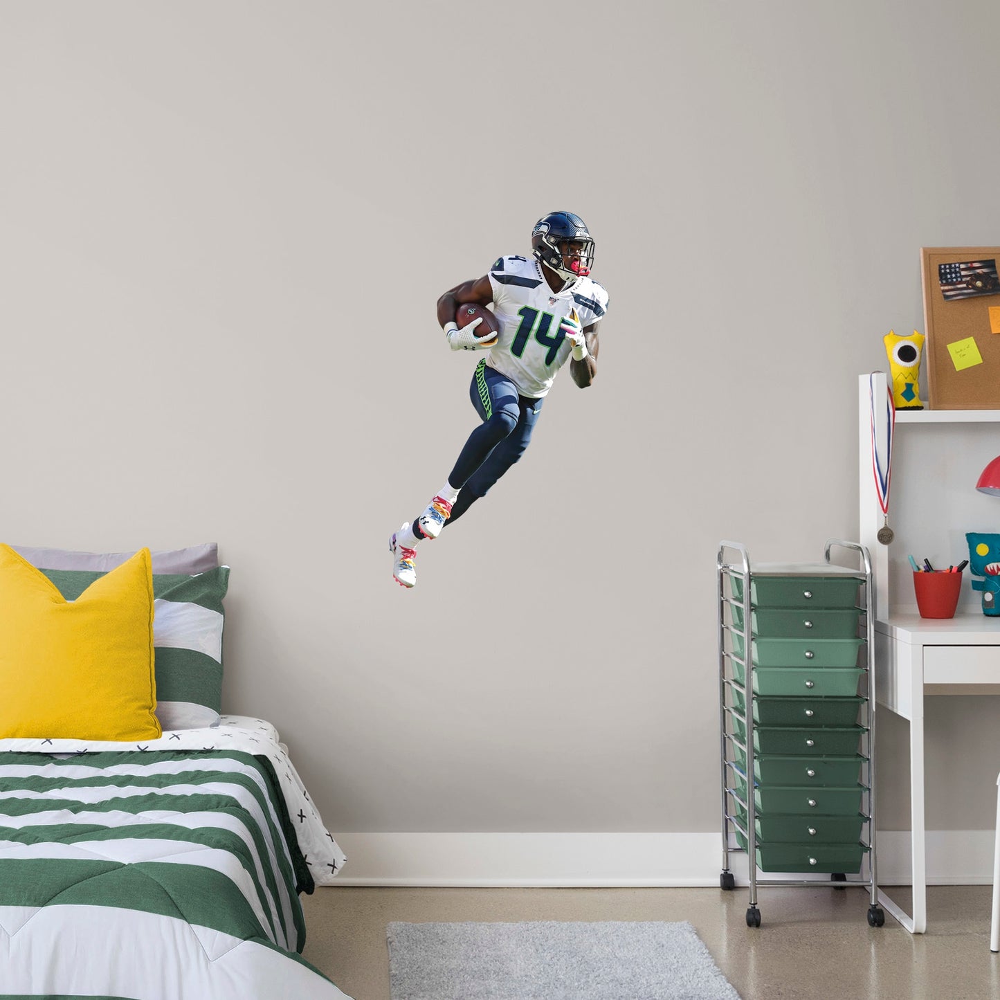 X-Large Athlete + 2 Decals (22"W x 38"H) Outmaneuver boring walls with this removable wall decal featuring D.K. Metcalf showing other players how to roll with it. This quality, giftable decal showcases Baby Bron in mid-sprint, clutching the football defensively while wearing the Seahawks' signature College Navy, Action Green, and Wolf Gray colors. This durable decal will help you demonstrate a strong offense in your bedroom, office, or entertainment room.