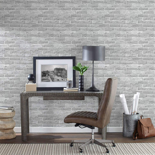 a home office featuring white brick peel and stick wallpaper