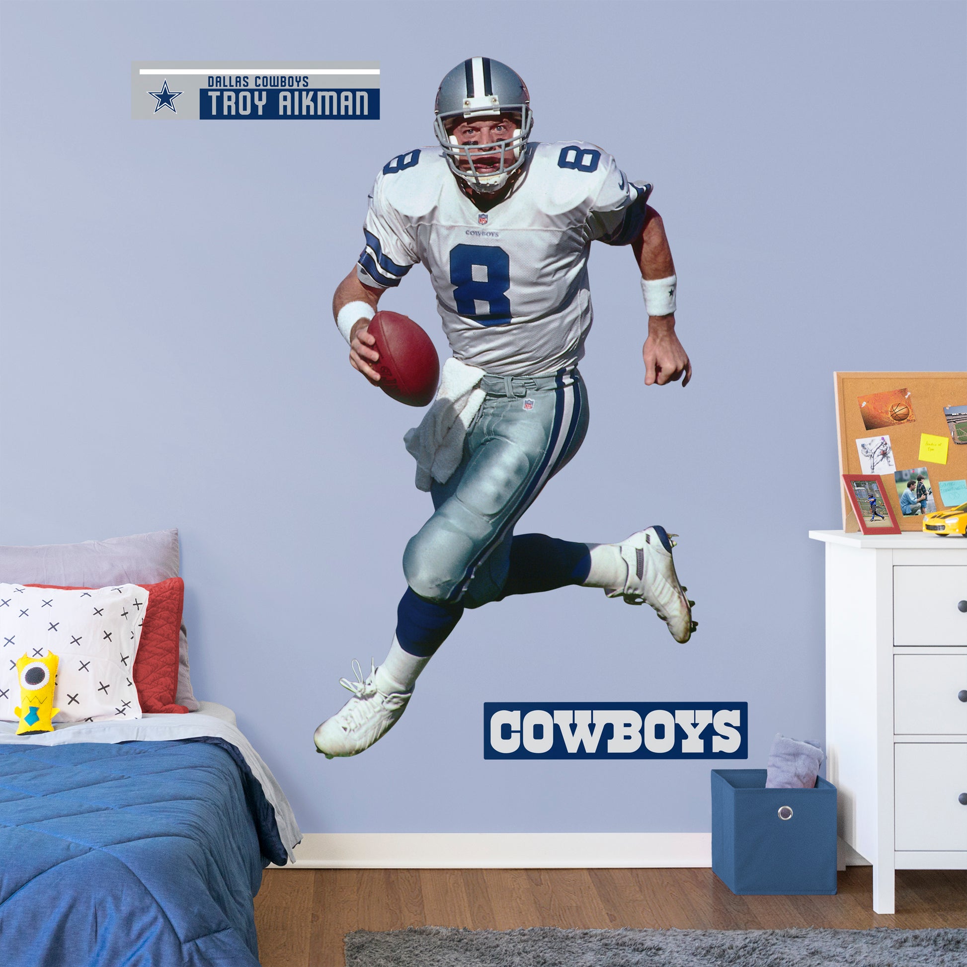 Life-Size Athlete + 2 Decals Quarterback with the Dallas Cowboys for 12 consecutive seasons and inducted in the Pro Football Hall of Fame in 2006, the IceMan can now be memorialized as one of the greats in your den or bedroom with this officially licensed NFL Troy Aikman: Legend removeable wall decal. Featuring the navy blue, metallic silver, royal blue, and white of America’s Team no flags will be called for this durable decal that ensures Aikman can be making passes for seasons to come.