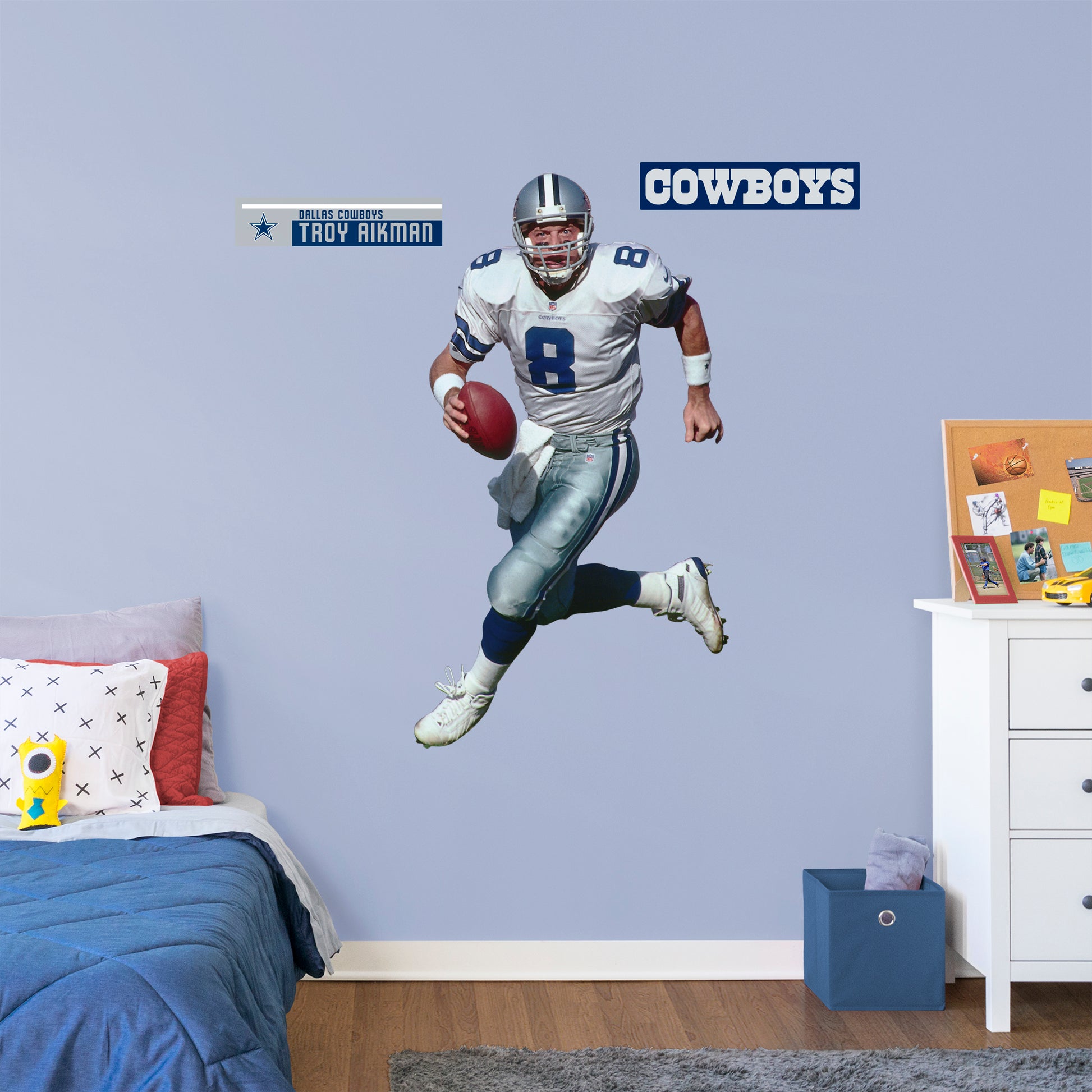 Giant Athlete + 2 Decals Quarterback with the Dallas Cowboys for 12 consecutive seasons and inducted in the Pro Football Hall of Fame in 2006, the IceMan can now be memorialized as one of the greats in your den or bedroom with this officially licensed NFL Troy Aikman: Legend removeable wall decal. Featuring the navy blue, metallic silver, royal blue, and white of America’s Team no flags will be called for this durable decal that ensures Aikman can be making passes for seasons to come.