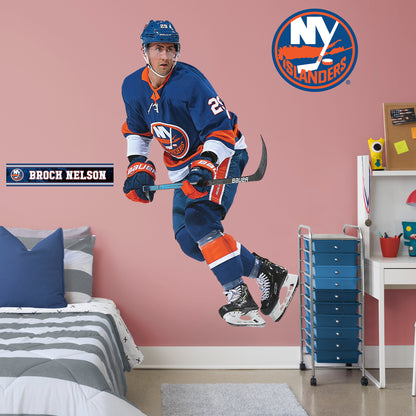 Life-Size Athlete + 2 Decals (51"W x 77"H) Brock Nelson quickly made his mark in the NHL when he lead the Islanders to victory, and now he's skating to life in your office, bedroom, or fan room in this Officially Licensed NHL wall decal. New York fans and NHL fanatics alike will love the touch of action that Nelson brings, and this durable and removable wall decal will definitely stand up to the challenge, no matter how many times you move and restick it!