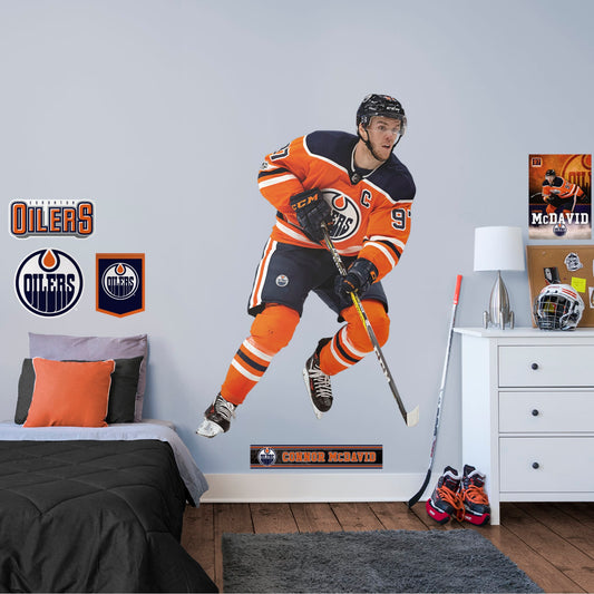 Life-Size Athlete + 7 Decals (49"W x 76"H) Prep to rep team captain McDavid and the Edmonton Oilers to another championship with this quality reusable logo collection. Nicknamed "McJesus" for his skill, this 1st overall 2015 NHL draft pick has scored many awards including the Hart Memorial Trophy. You'll be singing, "Oh, Canada," along with the team at Rogers Place when you post this durable logo in the home, office, or man-cave. O, Canada, we stand on guard for thee (and Connor McDavid!).