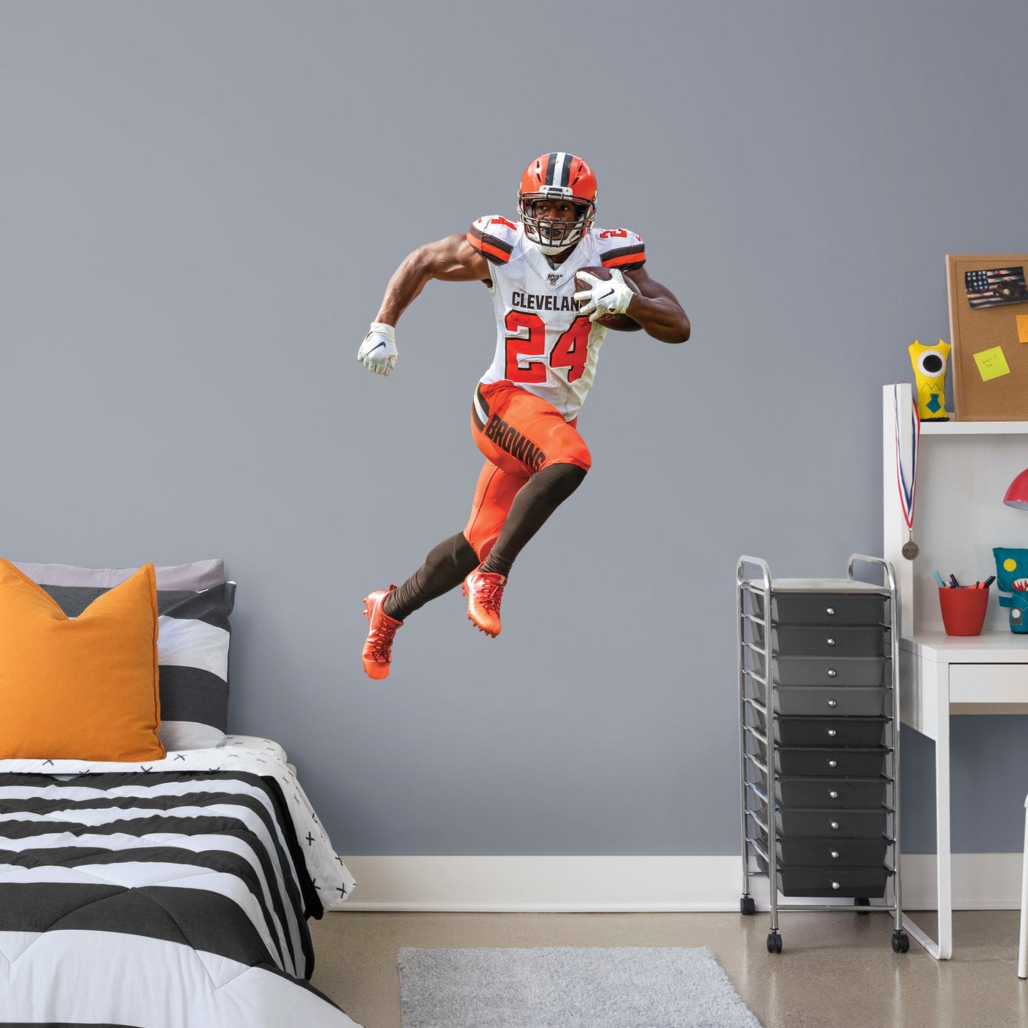 Giant Athlete + 2 Decals (32"W x 51"H) Heir to a Cleveland running back a tradition that includes the legendary Jim Brown, Nick Chubb is the new Browns powerhouse. Blessed with a blend of power, balance, and speed, the man they call Old School is a nightmare for AFC North foes. Now Dawg Pound fans can salute the former Georgia All-American with this removable wall decal collection. The premium vinyl decals are as durable as Chubb himself and ready to charge through a bonus room, bedroom, or dorm. Woof!