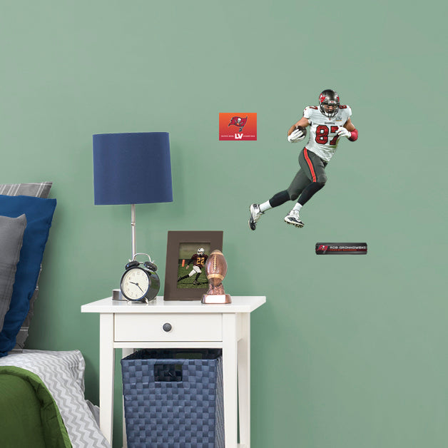 Large Athlete + 2 Decals (11"W x 16"H) Bring the action of the NFL into your home with a wall decal of Rob Gronkowski! High quality, durable, and tear resistant, you'll be able to stick and move it as many times as you want to create the ultimate football experience in any room!