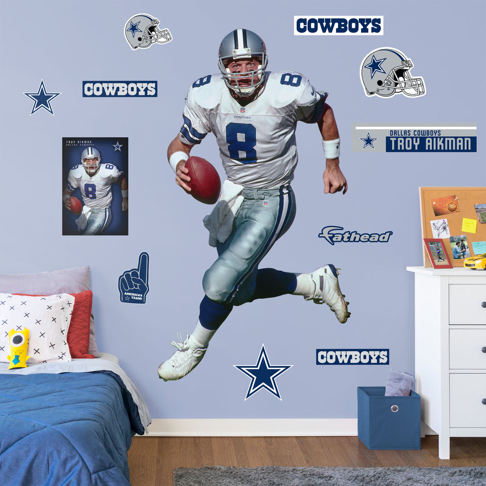 Life-Size Athlete + 11 Decals Quarterback with the Dallas Cowboys for 12 consecutive seasons and inducted in the Pro Football Hall of Fame in 2006, the IceMan can now be memorialized as one of the greats in your den or bedroom with this officially licensed NFL Troy Aikman: Legend removeable wall decal. Featuring the navy blue, metallic silver, royal blue, and white of America's Team no flags will be called for this durable decal that ensures Aikman can be making passes for seasons to come.