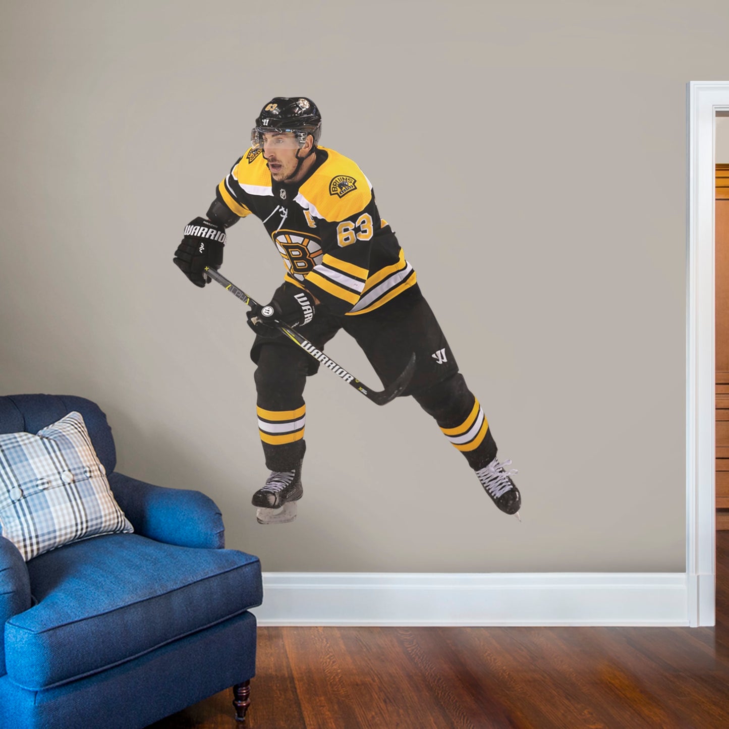 Life-Size Athlete + 2 Decals (58"W x 70"H) Bruins fans know that the opposing team should be scared when Brad Marchand hits the ice, and now you can bring that action to life in your own home with this Officially Licensed NHL Removable Wall Decal! Seen here in the Boston home uniform, this removable and reusable decal of Marchand is bold and durable, making it the perfect addition to your bedroom, office, or fan room. Go Bruins!