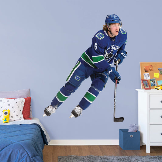 Life-Size Athlete + 2 Decals (56"W x 72"H) Everyone loves Brock Boeser, the first round pick from the 2015 draft, and now you can bring him to life in your bedroom, office, or fan room with this Officially Licensed NHL Wall Decal. Skating to life in the Canucks home uniform, this removable wall decal of Boeser is sure to bring some action to your home, no matter how many times you need to move and restick it!
