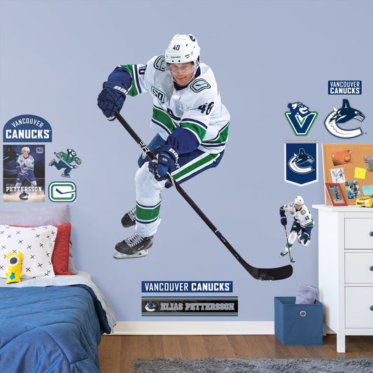 Life-Size Athlete + 11 Decals (61"W x 77"H) Elias Peterson has been a standout in the league since the very beginning, and now you can bring him to life in your own home with this Officially Licensed NHL Removable Wall Decal! Canucks fans and NHL fanatics alike will love this durable and high quality wall decal and, with the excitement it brings to your space, it's almost as good as being at Rogers Arena!
