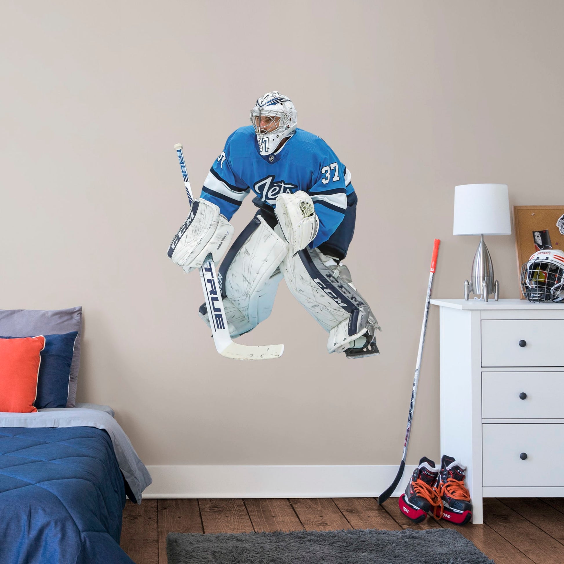 Giant Athlete + 2 Decals (38"W x 47"H) Opposing teams should be worried when they see Connor Hellebuyck in the goal, and now you can bring his epic defense skills to life in your own home with this Officially Licensed NHL removable wall decal. Pictured here ready to stop any puck that comes his way, this wall decal of Hellebuyck will make the perfect addition to your bedroom, office, or fan room, and it even makes a great gift for your favorite Jets fanatic!