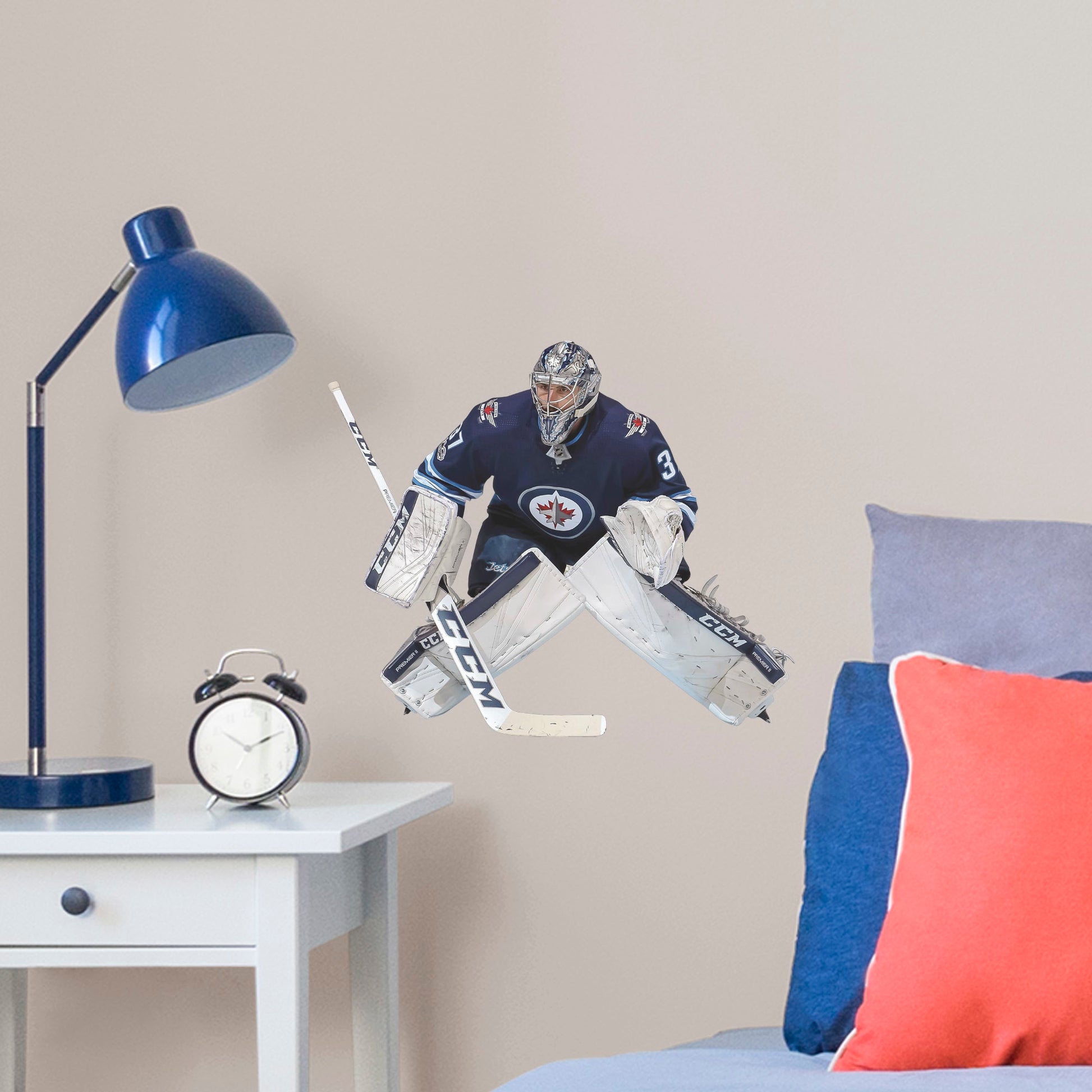 Large Athlete + 2 Decals (14"W x 12"H) Opposing teams should be worried when they see Connor Hellebuyck in the goal, and now you can bring his epic defense skills to life in your own home with this Officially Licensed NHL removable wall decal. Pictured here ready to stop any puck that comes his way, this wall decal of Hellebuyck will make the perfect addition to your bedroom, office, or fan room, and it even makes a great gift for your favorite Jets fanatic!