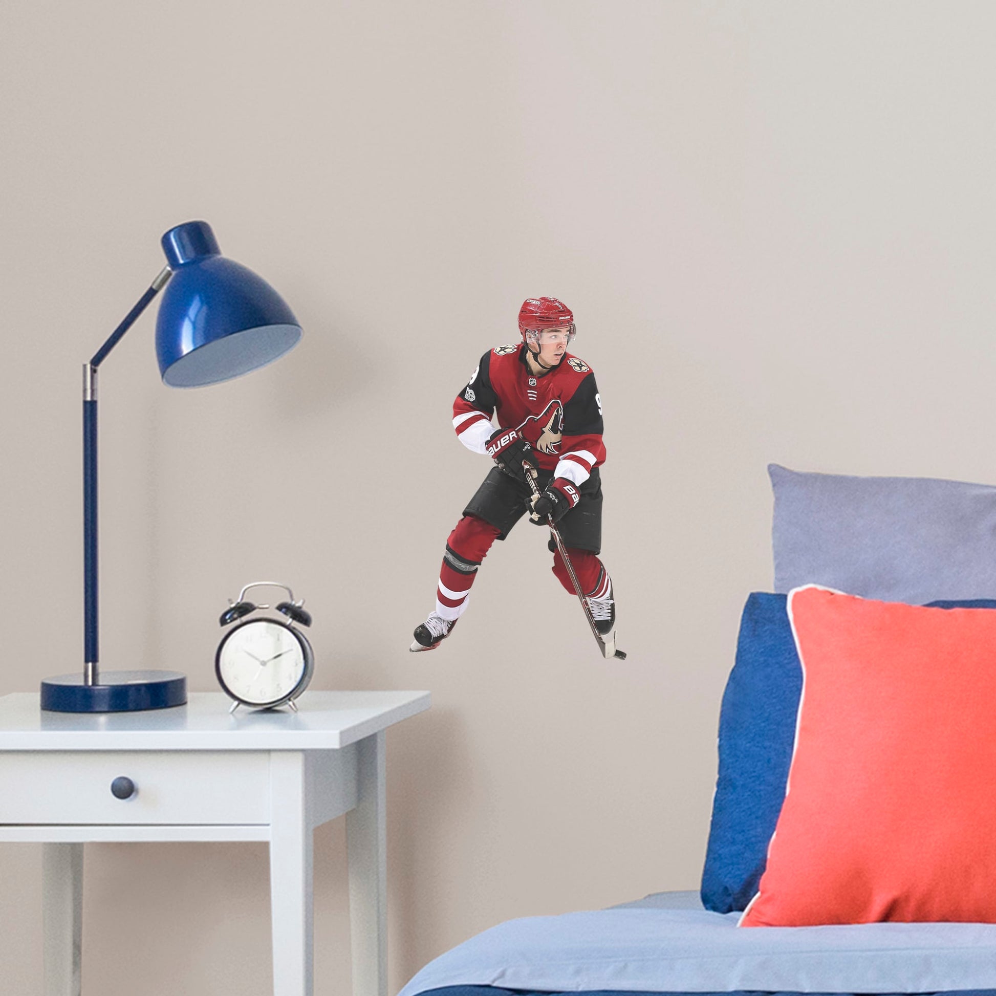 Large Athlete + 1 Decal (10"W x 17"H) Drafted seventh overall in the 2016, left wing player Clayton Keller is melting ice at Gila River Arena in Glendale. Cheer on Kellsy as he leads the Coyotes on to another championship with this distinctive colorful officially licensed NHL wall decal. Make a slap shot on a wall in your home, office, or coyote fan-den with this giftable reusable NHL decal. Perfect gift idea for a fan!