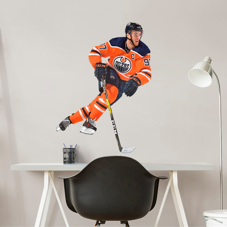 You can't always make it to Rogers Place in person, but now you can bring the action on the ice to life in your own home with this Officially Licensed NHL removable wall decal of the Oilers' very own Connor McDavid! Widely considered to be one of the best players in the league, this decal of the beloved Oilers captain is sure to bring some excitement to your bedroom, office, or fan room.