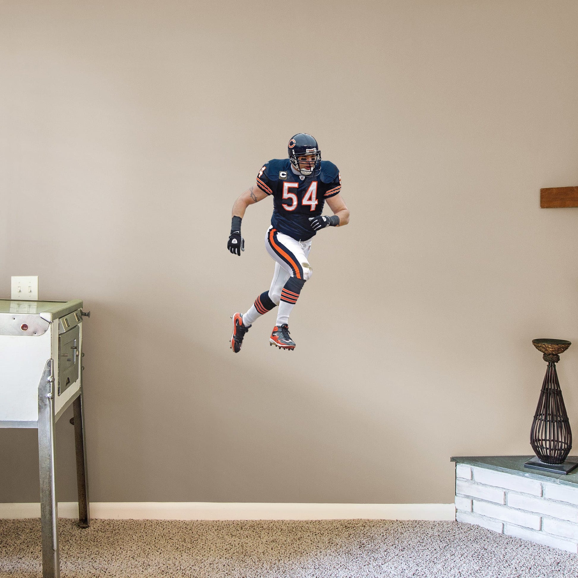 X-Large Athlete + 2 Decals (21"W x 38"H) For 13 years, the Chicago Bears watched #54 earn his place as one of the Top 100 Bears of All time. Rep the navy blue and burnt orange with a high-grade vinyl decal of Da Bears legend Brian Urlacher. Removable, reusable, and tear-resistant, this Hall of Famer is great for bedrooms, man caves, or even as a temporary party decoration. Bear down, Chicago Bears!