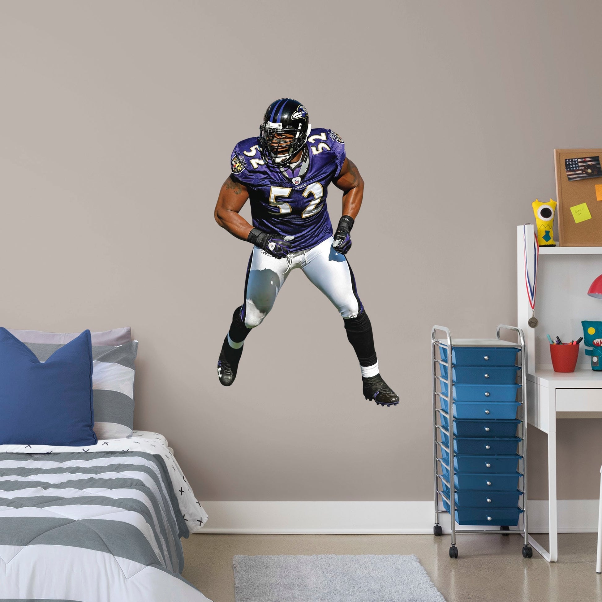 Giant Athlete + 2 Decals (31"W x 51"H) He’s the second linebacker ever to win the NFL’s Super Bowl MVP Award, and now, Brickwall, a.k.a. Ray Lewis, is ready for the bedroom, living room or locker room. This rugged, removable wall decal features the full figure of two-time Super Bowl champion No. 52 in his black, purple and metallic gold Baltimore Ravens best. Go Ravens!