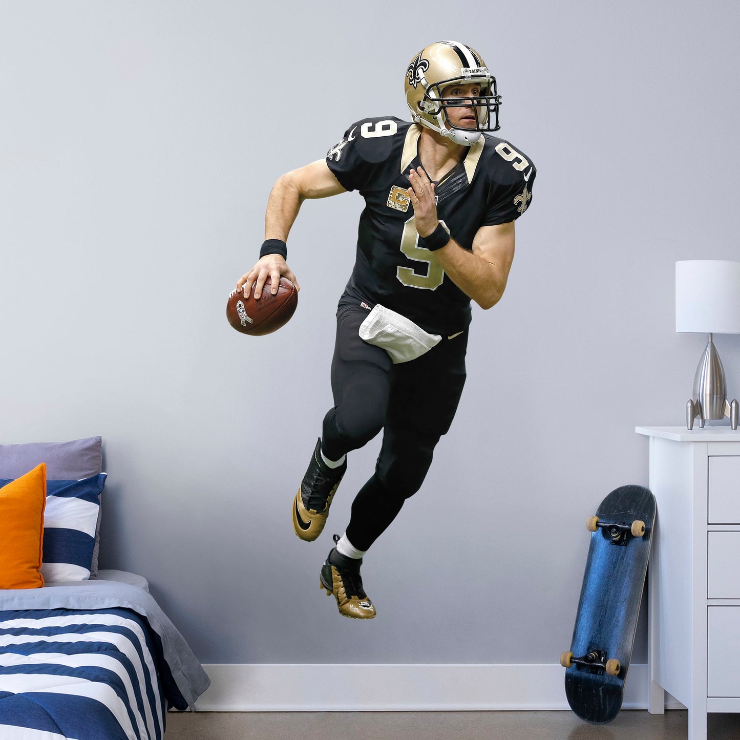 Life-Size Athlete + 1 Decals (29"W x 76"H) Super Bowl MVP, NFL Sportsman of the Year, and perennial fan favorite Drew Brees hustles across your man cave wall with this durable vinyl wall decal. Showcasing the Saints' signature black and old gold with the home game uniform, this decal turns your sports bar, bedroom, or dorm room into your personal Superdome. The reusable, high quality vinyl won't damage walls, making it the perfect choice if you need to take your Saints fandom on the road.
