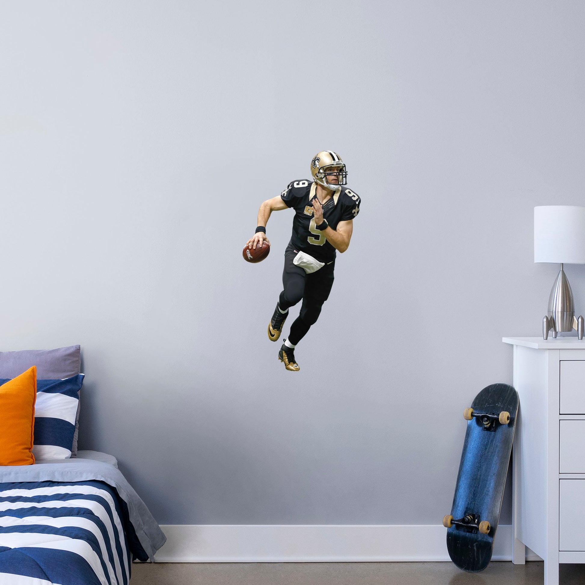 X-Large Athlete + 1 Decal (15"W x 39"H) Super Bowl MVP, NFL Sportsman of the Year, and perennial fan favorite Drew Brees hustles across your man cave wall with this durable vinyl wall decal. Showcasing the Saints' signature black and old gold with the home game uniform, this decal turns your sports bar, bedroom, or dorm room into your personal Superdome. The reusable, high quality vinyl won't damage walls, making it the perfect choice if you need to take your Saints fandom on the road.