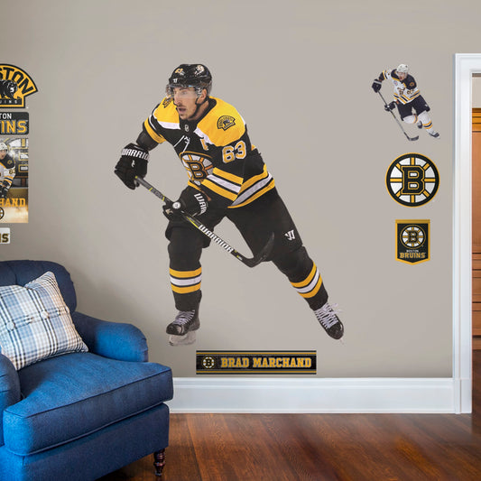 Life-Size Athlete + 9 Decals (58"W x 70"H) Bruins fans know that the opposing team should be scared when Brad Marchand hits the ice, and now you can bring that action to life in your own home with this Officially Licensed NHL Removable Wall Decal! Seen here in the Boston home uniform, this removable and reusable decal of Marchand is bold and durable, making it the perfect addition to your bedroom, office, or fan room. Go Bruins!