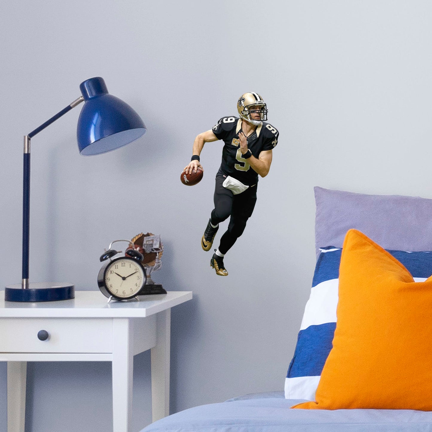 Large Athlete + 1 Decals (7"W x 17"H) Super Bowl MVP, NFL Sportsman of the Year, and perennial fan favorite Drew Brees hustles across your man cave wall with this durable vinyl wall decal. Showcasing the Saints' signature black and old gold with the home game uniform, this decal turns your sports bar, bedroom, or dorm room into your personal Superdome. The reusable, high quality vinyl won't damage walls, making it the perfect choice if you need to take your Saints fandom on the road.
