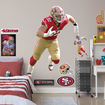 Life-Size Athlete + 9 Decals (54"W x 74"H) NFL pundits tagged Nick Bosa a can't-miss prospect, and Frisco's No. 2 draft pick dug deep and struck gold in 2019. Named the NFL Defensive Rookie of the Year, the sack master from Ohio State led the 49ers to the NFC title. Now you can honor one of Sourdough Sam's favorite sons with an officially licensed wall decal. Constructed from high-quality vinyl, the decal looks good in a bedroom or bonus room and is a no-brainer gift for any member of The Faithful.