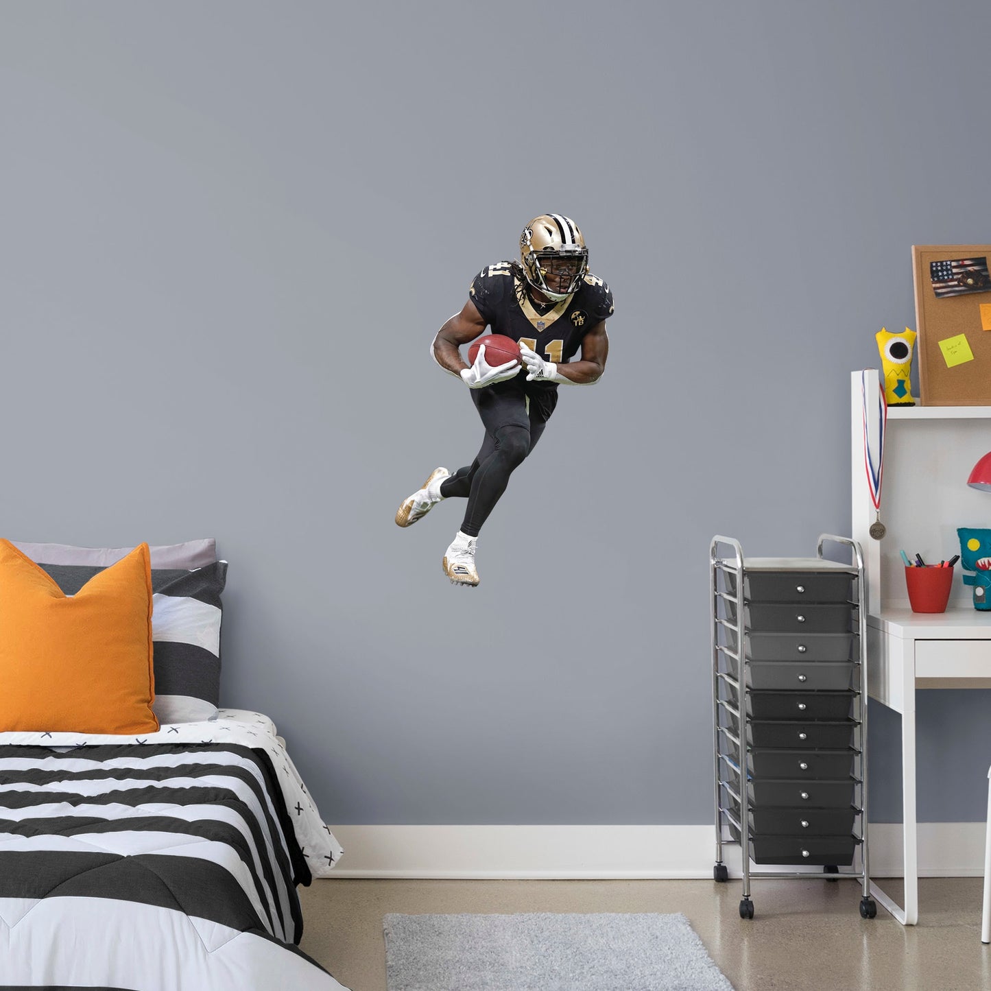 Life-Size Athlete + 2 Decals (43"W x 74"H) Who Dat! Running back Alvin Kamara of the New Orleans Saints had a stellar start to his NFL career with an impressive 32 TDs in his first two seasons - an MVP in the making. Deck your walls in black and gold with a high-grade vinyl decal of the Saints' #41. It won't fade or tear, so remove it and reuse it wherever you watch the big game. Geaux Saints!