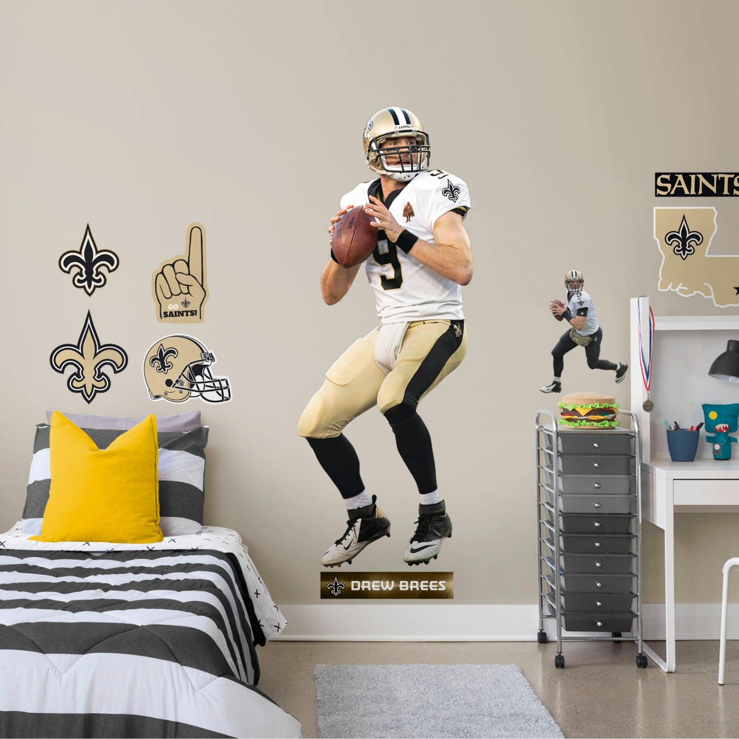 Life-Size Athlete + 11 Decals (29"W x 76"H) Let your favorite Saints quarterback go marching in your man cave, sports bar, or training space with this durable Drew Brees vinyl wall decal. The MVP of Super Bowl XLIV and one of the greatest quarterbacks of all time, Brees is a player you'll be proud to display in your personal Superdome. Should you call an audible and need to relocate, the high-quality decal is easy to remove and display in a new space.