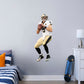 Giant Athlete + 1 Decals (20"W x 51"H) Let your favorite Saints quarterback go marching in your man cave, sports bar, or training space with this durable Drew Brees vinyl wall decal. The MVP of Super Bowl XLIV and one of the greatest quarterbacks of all time, Brees is a player you'll be proud to display in your personal Superdome. Should you call an audible and need to relocate, the high-quality decal is easy to remove and display in a new space.