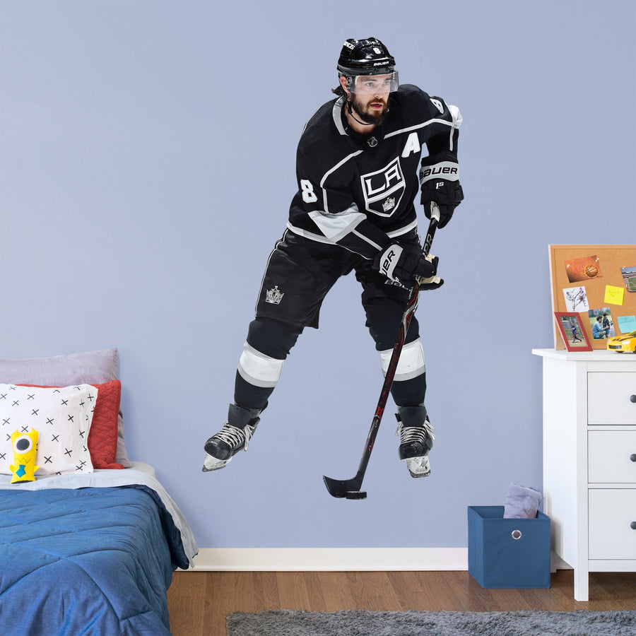 Life-Size Athlete + 2 Decals (44"W x 77"H) Drew Doughty has been a star from the very start and now Los Angeles Kings fanatics can bring him to life in your own home with this Officially Licensed NHL Removable Wall Decal. Shown here in action in the Kings home uniform, this wall decal is durable and high quality and is sure to bring the action to your bedroom, office, or fan room.