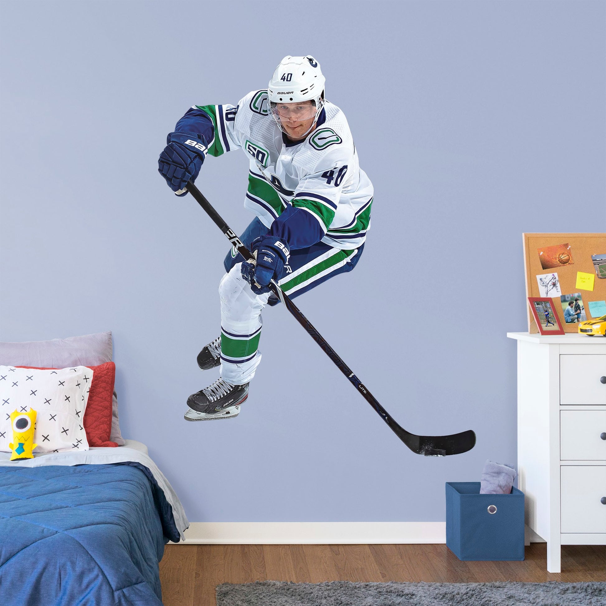 Life-Size Athlete + 2 Decals (61"W x 77"H) Elias Peterson has been a standout in the league since the very beginning, and now you can bring him to life in your own home with this Officially Licensed NHL Removable Wall Decal! Canucks fans and NHL fanatics alike will love this durable and high quality wall decal and, with the excitement it brings to your space, it's almost as good as being at Rogers Arena!