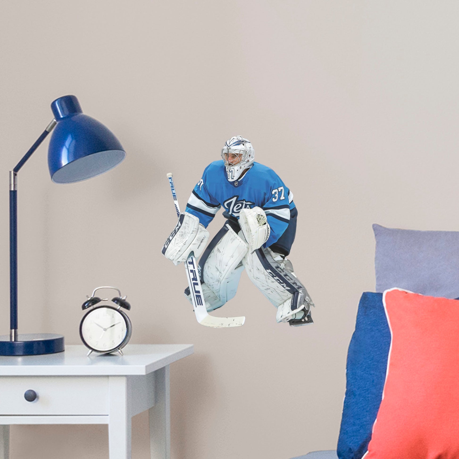 Large Athlete + 2 Decals (12"W x 15"H) Opposing teams should be worried when they see Connor Hellebuyck in the goal, and now you can bring his epic defense skills to life in your own home with this Officially Licensed NHL removable wall decal. Pictured here ready to stop any puck that comes his way, this wall decal of Hellebuyck will make the perfect addition to your bedroom, office, or fan room, and it even makes a great gift for your favorite Jets fanatic!