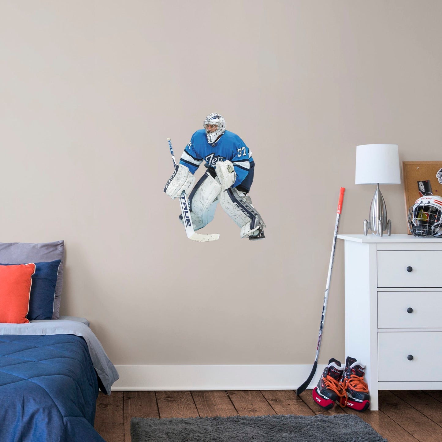 X-Large Athlete + 2 Decals (24"W x 31"H) Opposing teams should be worried when they see Connor Hellebuyck in the goal, and now you can bring his epic defense skills to life in your own home with this Officially Licensed NHL removable wall decal. Pictured here ready to stop any puck that comes his way, this wall decal of Hellebuyck will make the perfect addition to your bedroom, office, or fan room, and it even makes a great gift for your favorite Jets fanatic!