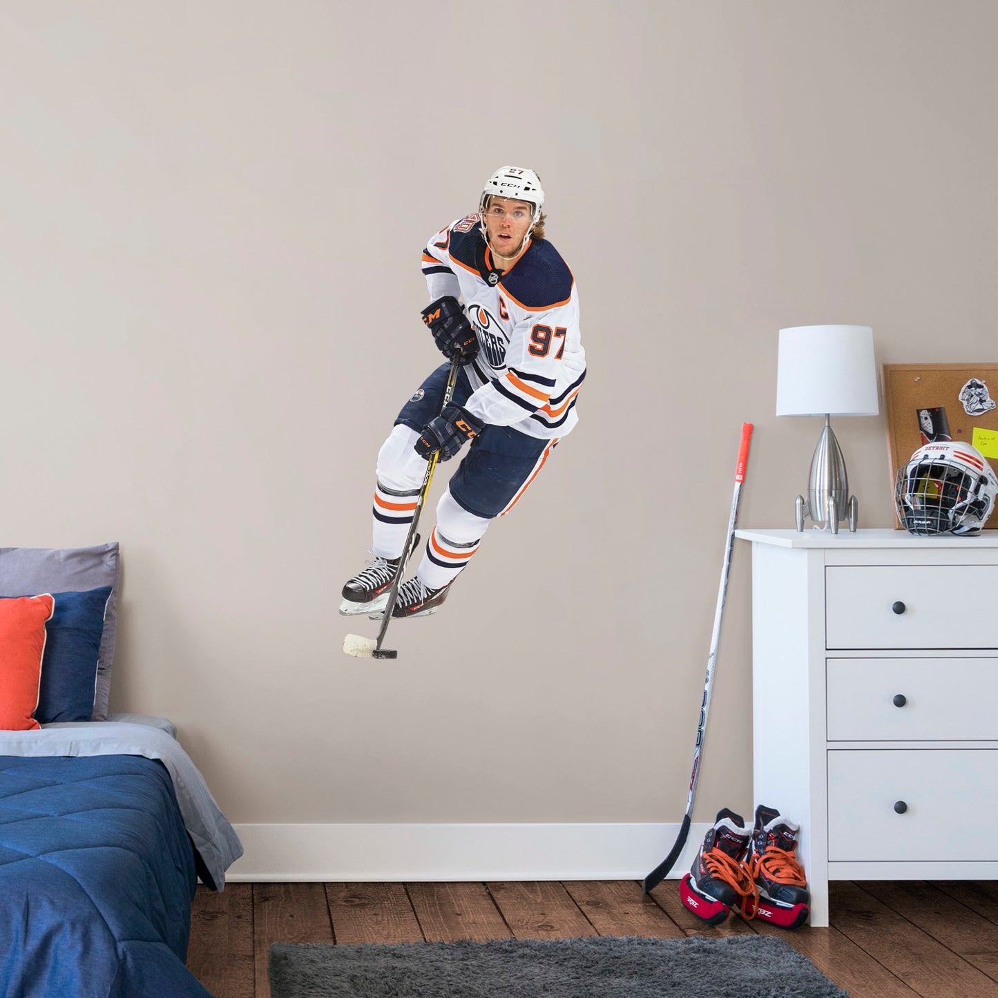 Giant Athlete + 2 Team Decals (26"W x 51"H) Widely considered to be among the best NHL players in the world, Edmonton Oilers centre and team captain Connor McDavid has cemented himself as a high-caliber player for the Oilers. Affectionately referred to as “Connor McSaviour” and the “Canadian Super Promise,” this officially licensed NHL wall decal depicts the full frame of the Edmonton Oiler’s 2015 first overall draft pick in his Away uniform.