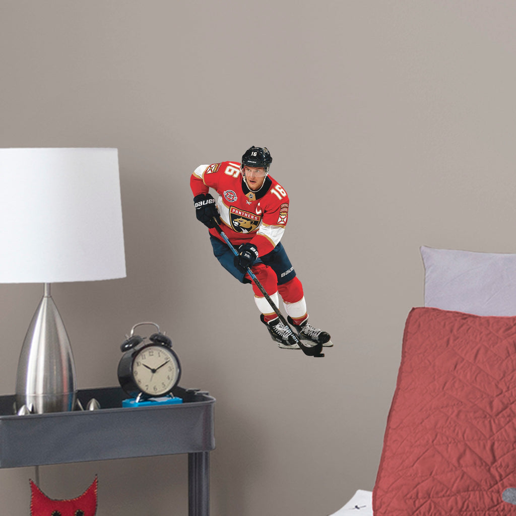 Giant Athlete + 2 Team Decals (36"W x 78"H) NHL fans and Panthers fanatics alike love Aleksander Barkov, the clutch captain from Florida, and now you can bring his skill to life in your own home! Seen here in action on the ice, this durable and bold wall decal will make the perfect addition to your bedroom, office, fan room, or any spot in your house!