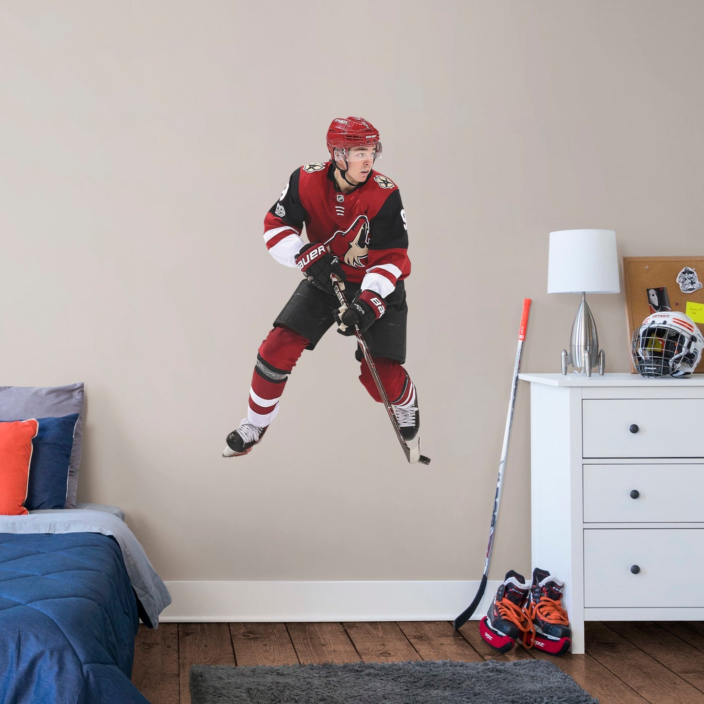 Giant Athlete + 1 Decal (31"W x 51"H) Drafted seventh overall in the 2016, left wing player Clayton Keller is melting ice at Gila River Arena in Glendale. Cheer on Kellsy as he leads the Coyotes on to another championship with this distinctive colorful officially licensed NHL wall decal. Make a slap shot on a wall in your home, office, or coyote fan-den with this giftable reusable NHL decal. Perfect gift idea for a fan!