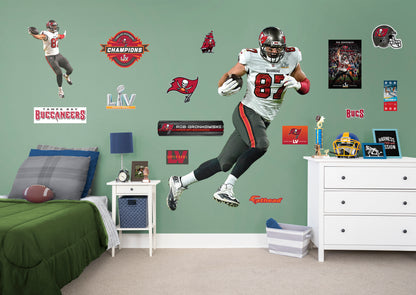 Life-Size Athlete + 14 Decals (51"W x 78"H) Bring the action of the NFL into your home with a wall decal of Rob Gronkowski! High quality, durable, and tear resistant, you'll be able to stick and move it as many times as you want to create the ultimate football experience in any room!