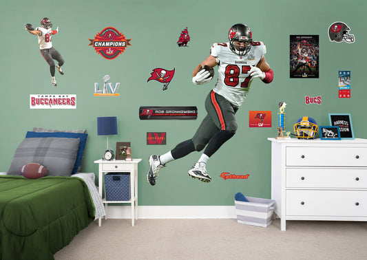 Life-Size Athlete + 14 Decals (51"W x 78"H) Bring the action of the NFL into your home with a wall decal of Rob Gronkowski! High quality, durable, and tear resistant, you'll be able to stick and move it as many times as you want to create the ultimate football experience in any room!