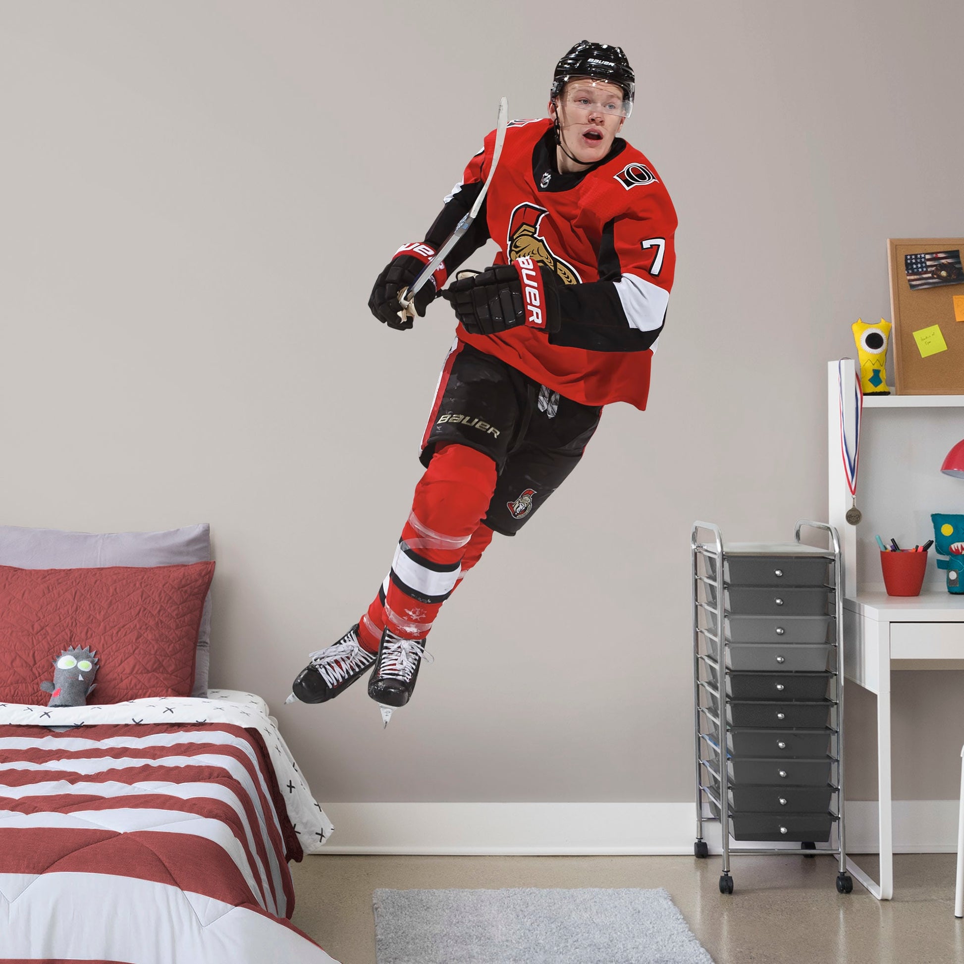 Life-Size Athlete + 2 Team Decals (44"W x 77"H) Power forward Brady Tkachuk quickly made his mark in the NHL when he lead the Senators to victory, and now he's skating to life in your office, bedroom, or fan room in this Officially Licensed NHL wall decal. Ottawa fans and NHL fanatics alike will love the touch of action that Tkachuk brings, and this durable and removable wall decal will definitely stand up to the challenge, no matter how many times you move and restick it!
